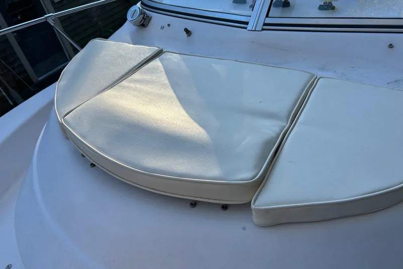 Slide: The Image of Cushioned seating on 1998 Grady-White Seafarer 226 boat deck, featuring white upholstery. - 5