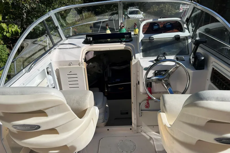 Slide: The Image of 1998 Grady-White Seafarer 226 boat interior with steering wheel and seating. - 7