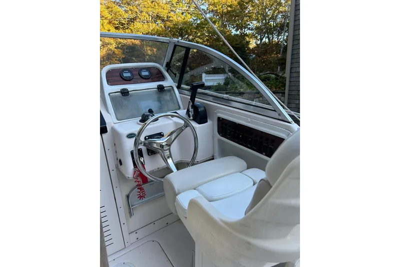 Slide: The Image of 1998 Grady-White Seafarer 226 boat cockpit with steering wheel and controls. - 8