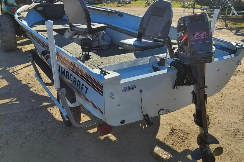 Slide: The Image of 1997 Alumacraft Backtroller 14 boat with Mercury 25 outboard motor, parked on dirt. - 10