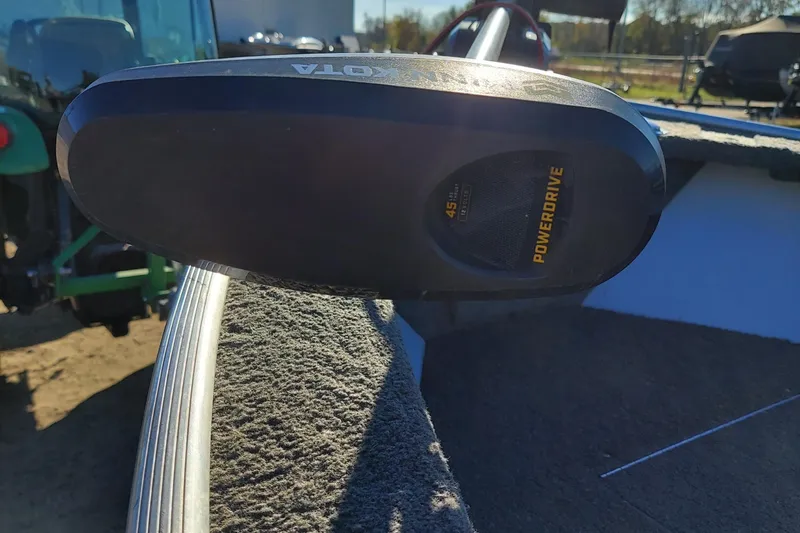 Slide: The Image of 1997 Alumacraft Backtroller 14 boat with PowerDrive motor, outdoor setting. - 6