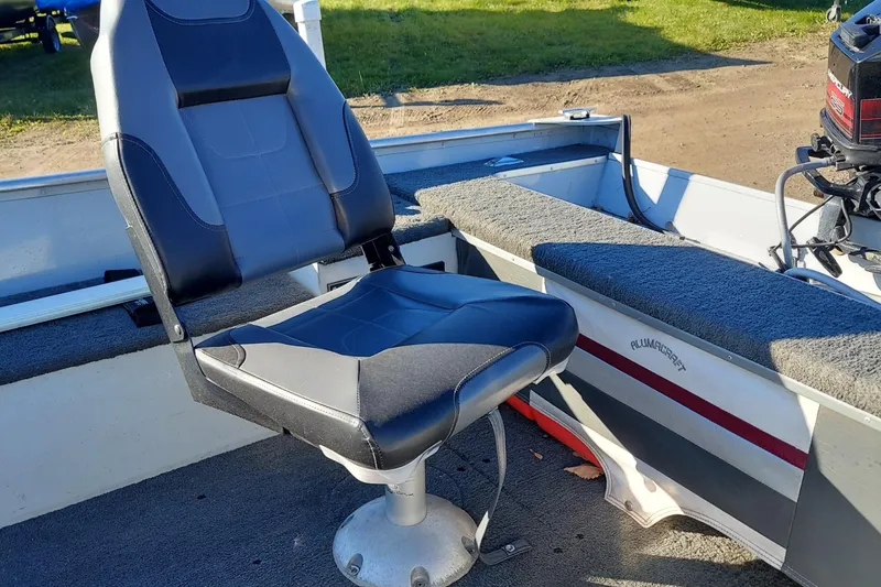 Slide: The Image of 1997 Alumacraft Backtroller 14 boat interior with swivel seat and motor. - 9
