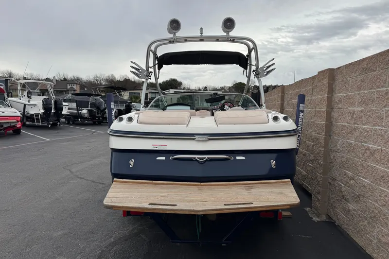 Slide: The Image of 2006 MasterCraft X30 boat in a parking lot, rear view with wakeboard tower. - 4