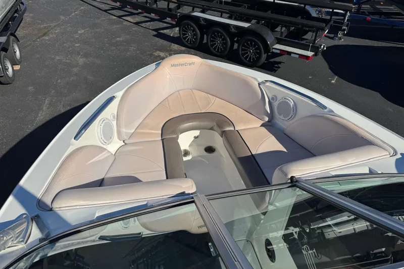 Slide: The Image of 2006 MasterCraft X30 boat interior with beige seating and speakers. - 5