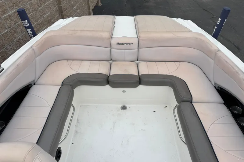 Slide: The Image of 2006 MasterCraft X30 boat interior with beige and gray seating arrangement. - 8