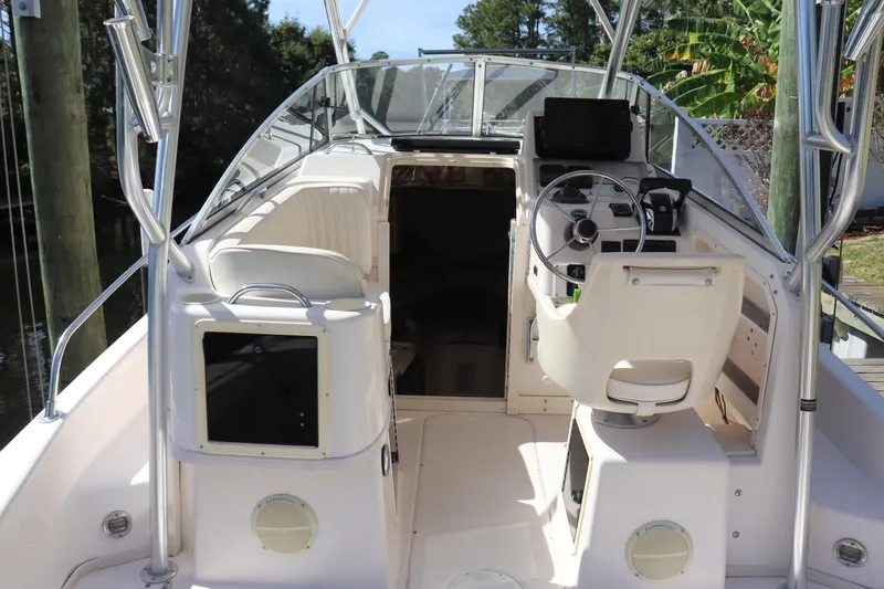 Slide: The Image of 1999 Grady-White Islander 268 boat interior with steering wheel and seating area. - 12