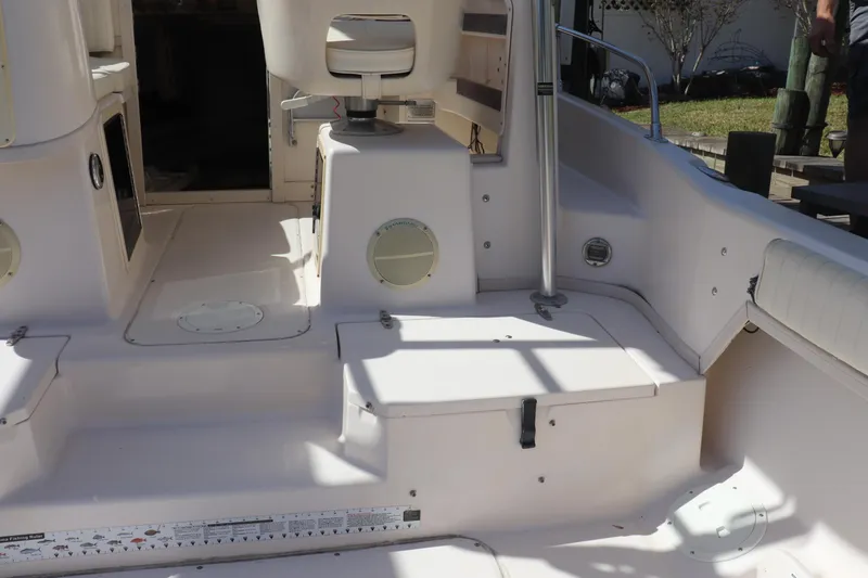 Slide: The Image of 1999 Grady-White Islander 268 boat interior with seating and storage compartments. - 14