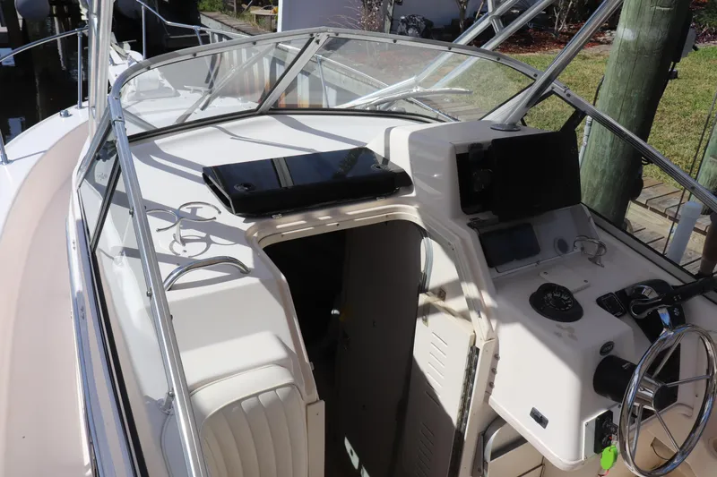 Slide: The Image of 1999 Grady-White Islander 268 boat cockpit with steering wheel and control panel. - 15