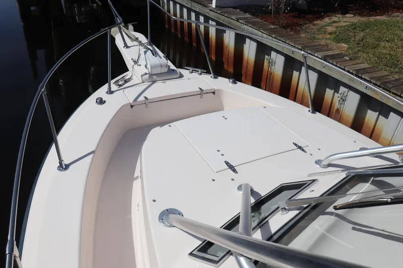 Slide: The Image of 1999 Grady-White Islander 268 boat deck with stainless steel railings and anchor. - 16