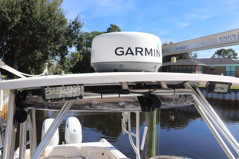 Slide: The Image of 1999 Grady-White Islander 268 boat with Garmin radar, docked by a serene waterfront. - 22