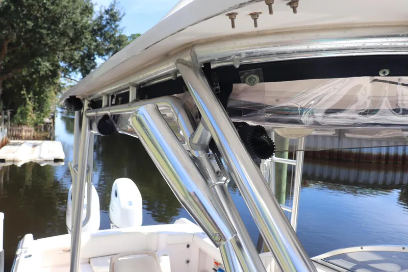 Slide: The Image of 1999 Grady-White Islander 268 boat with stainless steel fittings, docked by a serene waterway. - 23