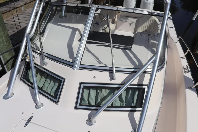 Slide: The Image of 1999 Grady-White Islander 268 boat with windshield and metal railings, docked. - 24