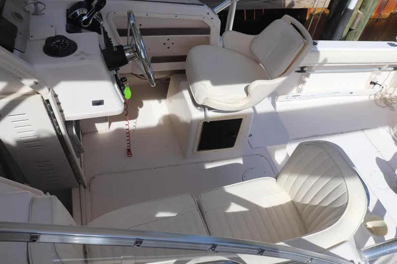 Slide: The Image of 1999 Grady-White Islander 268 boat interior with white seating and steering console. - 26