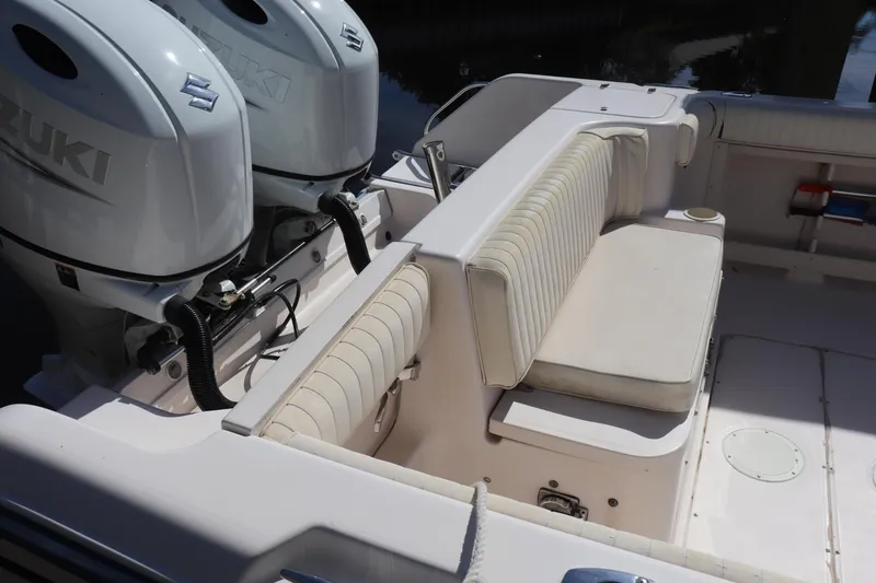 Slide: The Image of 1999 Grady-White Islander 268 boat interior with Suzuki engines and cushioned seating. - 3