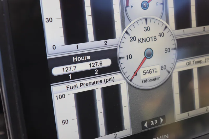 Slide: The Image of Close-up of a Grady-White Islander 268's digital dashboard displaying speed, hours, and fuel pressure. - 30