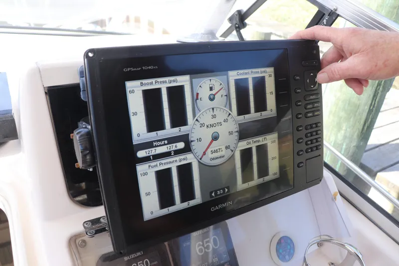 Slide: The Image of Garmin GPS display on 1999 Grady-White Islander 268 boat dashboard, showing engine metrics. - 31