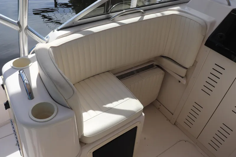 Slide: The Image of 1999 Grady-White Islander 268 boat interior with white cushioned seating and cup holders. - 36