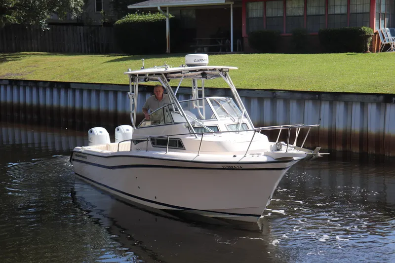 Slide: The Image of 1999 Grady-White Islander 268 boat navigating a narrow waterway. - 41