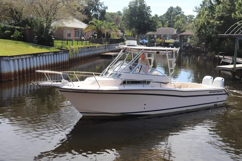 Slide: The Image of 1999 Grady-White Islander 268 boat cruising on a calm canal. - 52