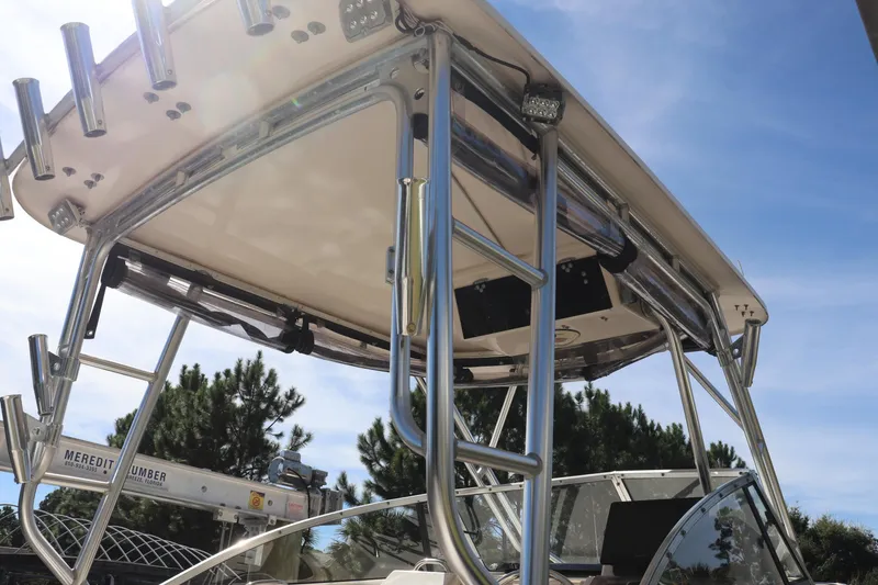 Slide: The Image of 1999 Grady-White Islander 268 boat with stainless steel T-top under clear blue sky. - 6