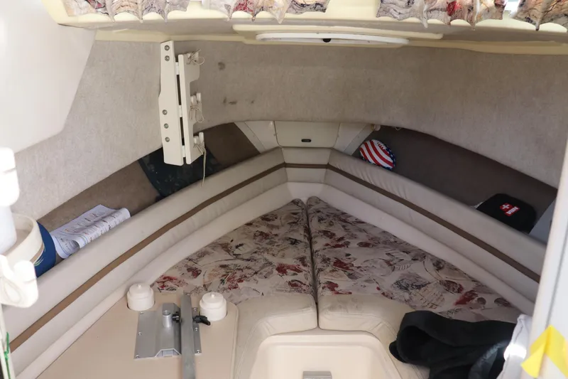 Slide: The Image of 1999 Grady-White Islander 268 cabin interior with patterned cushions and storage space. - 7