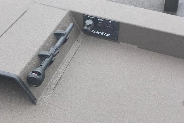 Slide: The Image of 2026 Alweld 1760VV Marsh Console CC boat on trailer, parked near road. - 4