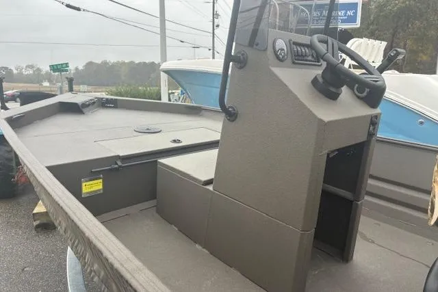 Slide: The Image of 2026 Alweld 1760VV Marsh Console CC boat with steering console, parked outdoors. - 7