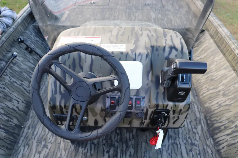 Slide: The Image of Steering console of 2026 SeaArk Shadow 18T CC boat with camouflage design. - 4