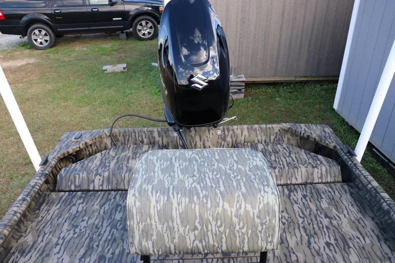 Slide: The Image of 2026 SeaArk Shadow 18T CC boat with camouflage interior and Suzuki outboard motor. - 6