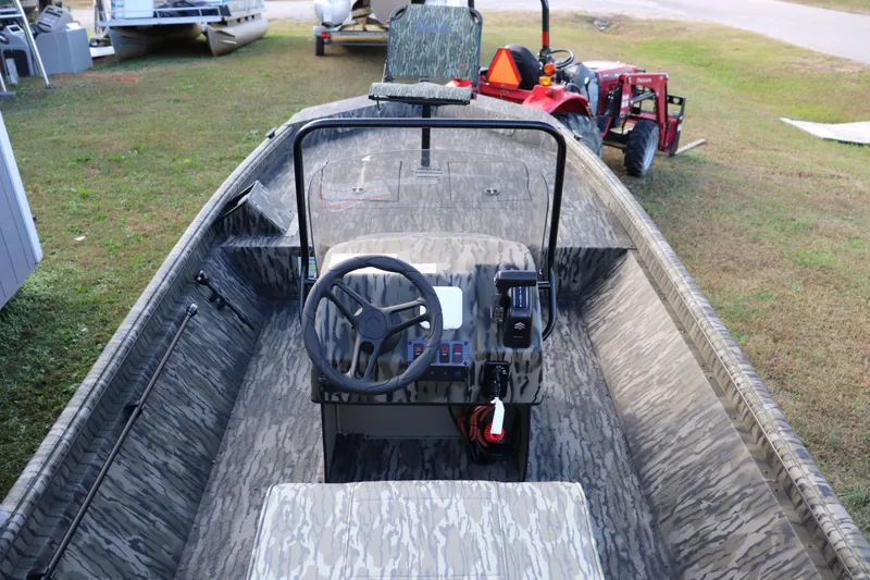 Slide: The Image of 2026 SeaArk Shadow 18T CC boat with camouflage interior and steering console. - 7