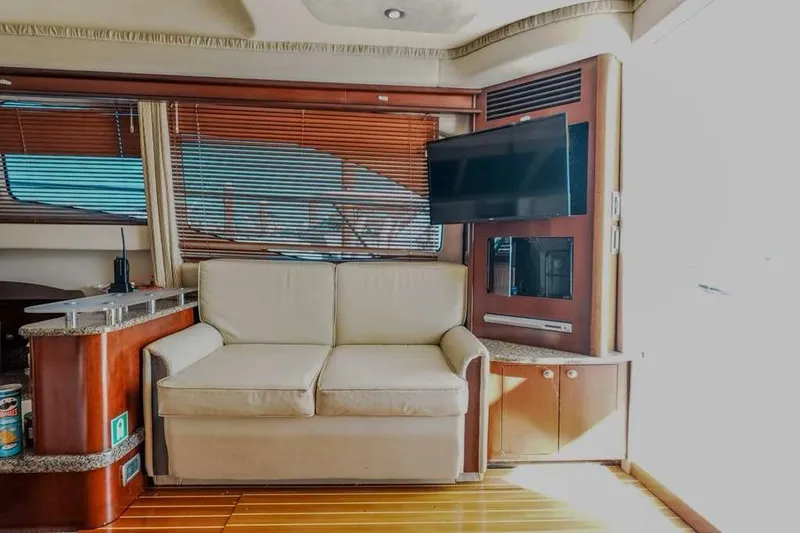 Slide: The Image of Interior of 2005 Sea Ray 420 Sedan Bridge with sofa and mounted TV. - 29
