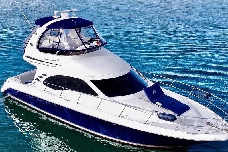 Slide: The Image of 2005 Sea Ray 420 Sedan Bridge yacht on calm blue water. - 3