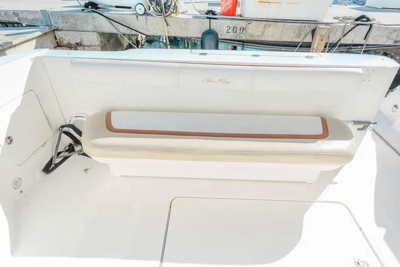 Slide: The Image of 2005 Sea Ray 420 Sedan Bridge boat seating area with white and tan cushions. - 30
