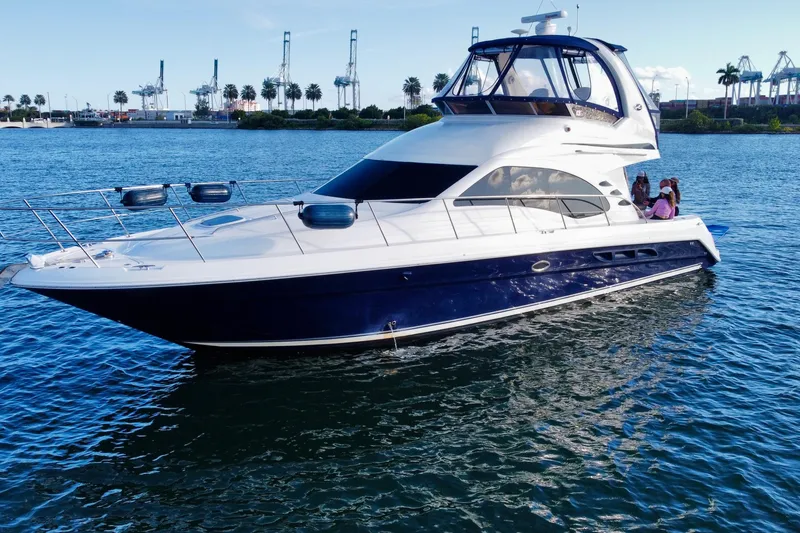 Slide: The Image of 2005 Sea Ray 420 Sedan Bridge yacht cruising on a sunny day. - 4