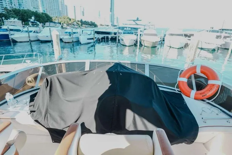 Slide: The Image of 2005 Sea Ray 420 Sedan Bridge at marina with life preserver and covered equipment. - 42