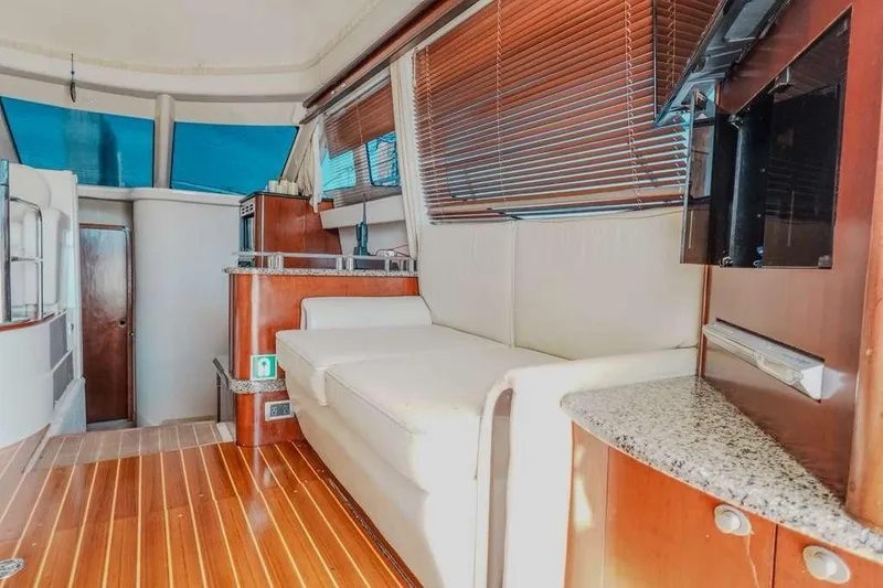 Slide: The Image of Interior of 2005 Sea Ray 420 Sedan Bridge with wood flooring and comfortable seating. - 45