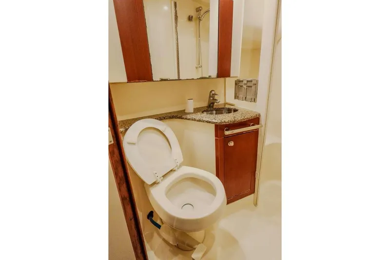 Slide: The Image of Bathroom interior of 2005 Sea Ray 420 Sedan Bridge yacht, featuring toilet and sink. - 46