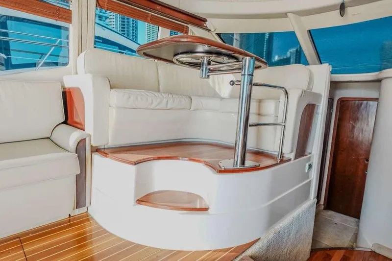 Slide: The Image of Luxurious interior of 2005 Sea Ray 420 Sedan Bridge yacht with elegant seating. - 48