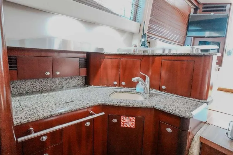 Slide: The Image of Luxurious kitchen area in 2005 Sea Ray 420 Sedan Bridge yacht with granite countertops. - 49