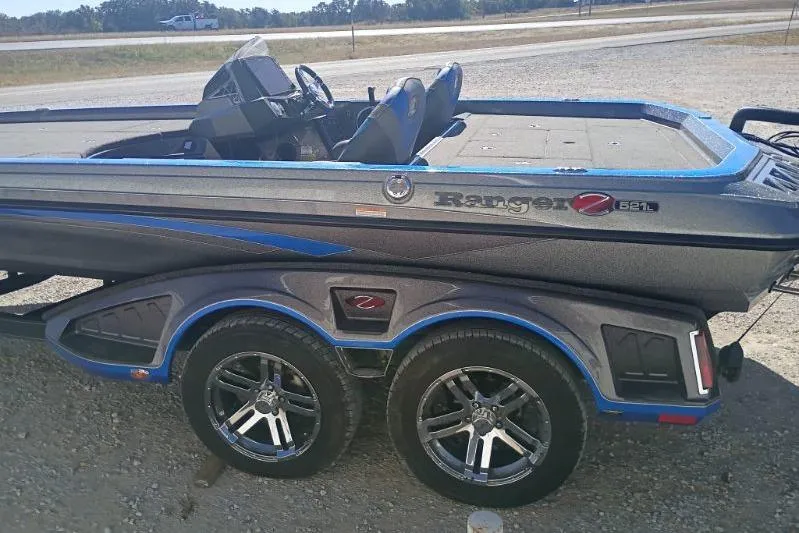 Slide: The Image of 2021 Ranger Z521L boat on trailer, featuring sleek design and dual axles. - 4
