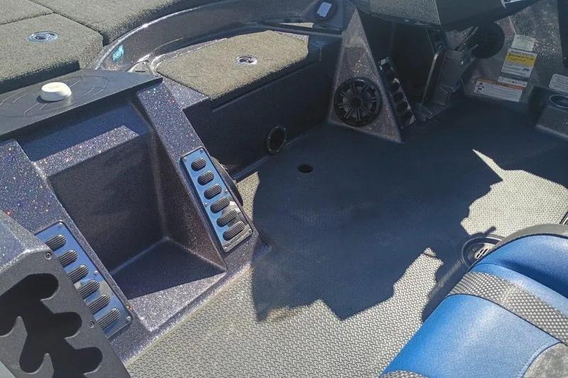Slide: The Image of 2021 Ranger Z521L boat interior with carpeted flooring and control panels. - 5