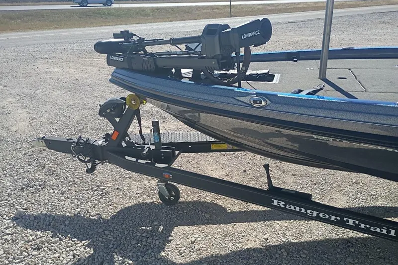 Slide: The Image of 2021 Ranger Z521L boat on trailer with Lowrance equipment, parked on gravel. - 6