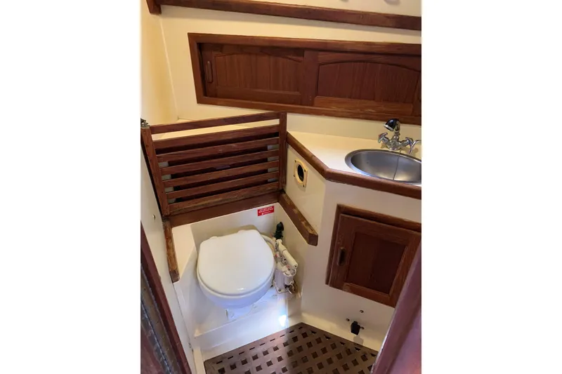 Slide: The Image of Bathroom interior of 1993 Pacific Seacraft 37 sailboat with wooden accents and compact design. - 10