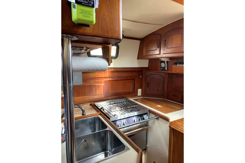 Slide: The Image of Interior of 1993 Pacific Seacraft 37 sailboat kitchen with stove and sink. - 11
