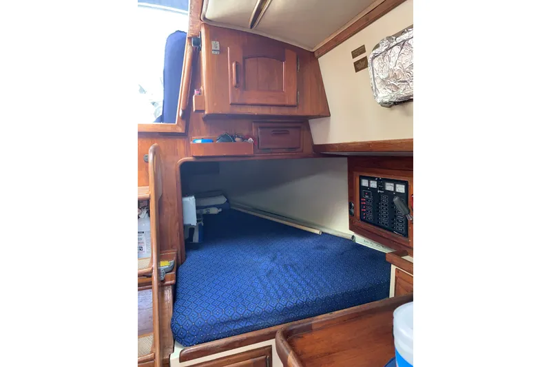 Slide: The Image of Cozy cabin interior of 1993 Pacific Seacraft 37 sailboat with blue bedding. - 13