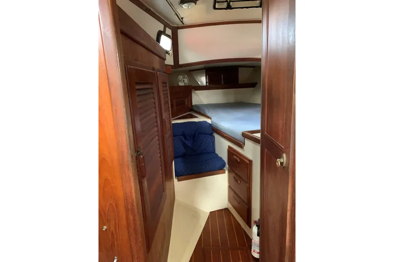 Slide: The Image of Interior of 1993 Pacific Seacraft 37 sailboat with wooden cabinetry and cozy sleeping area. - 7