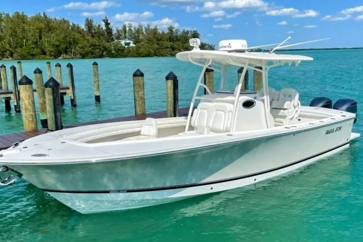 The Image of 2018 Regulator 28 boat docked in clear turquoise water, under a sunny sky. - 0