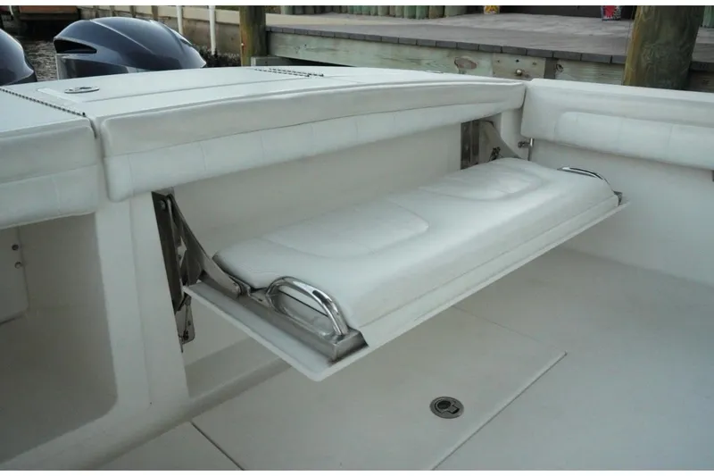 Slide: The Image of Fold-down seat on a 2018 Regulator 28 boat, showcasing sleek design and functionality. - 11