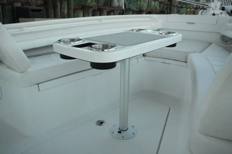 Slide: The Image of 2018 Regulator 28 boat interior with table and cup holders. - 25