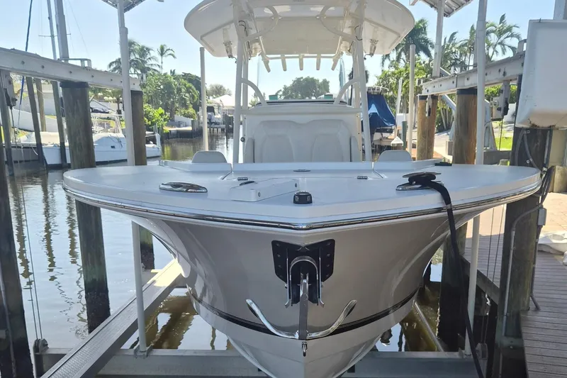 Slide: The Image of 2018 Regulator 28 boat on lift under canopy, docked near water. - 4